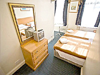 A twin room at 109 Warwick House Studios - all rooms feature private bathrooms and a kitchenette