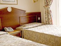 A typical bedroom at Pembridge Palace Hotel London