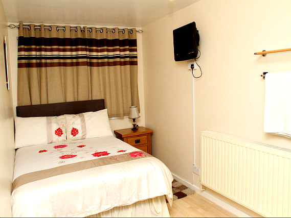 Put your feet up in front of the TV in your room at Julius Lodge Thamesmead