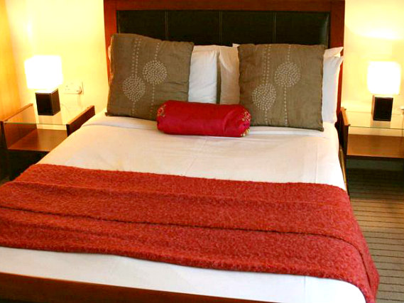 Rest easy in a comfortable bed in your room at Axiom W6 Hotel