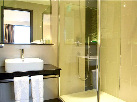 Relax in the private bathroom in your room at Crowne Plaza London Kingston