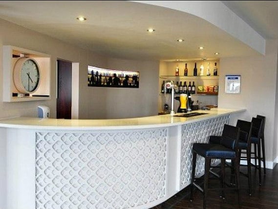 After a busy day, relax with a drink in the bar at Holiday Inn Express London Royal Docks Docklands