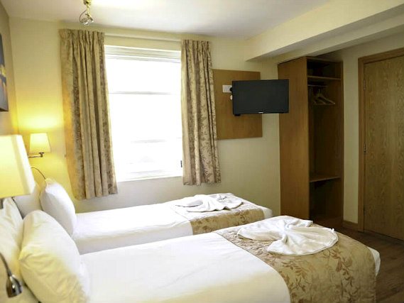 Une chambre avec lits jumeaux de Kings Cross Inn Hotel