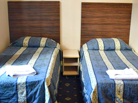 Une chambre avec lits jumeaux de Blair Victoria Hotel