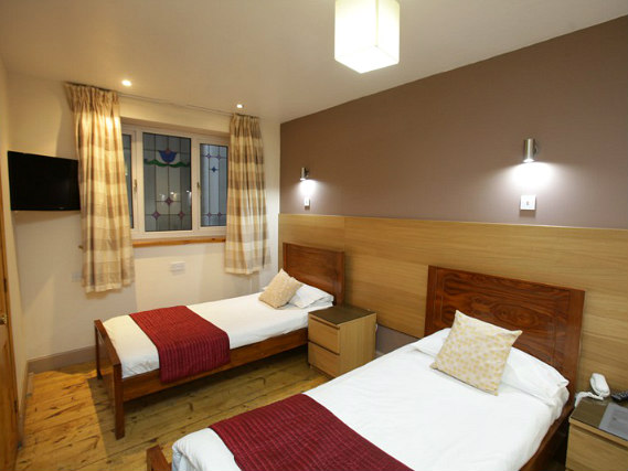 Une chambre avec lits jumeaux de Merchant City Inn