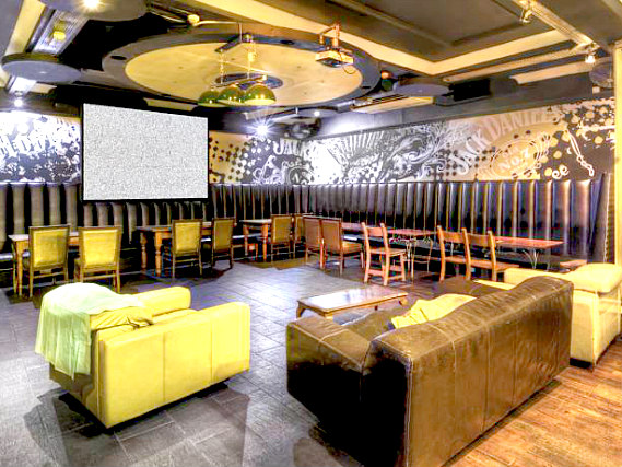 Relax in the lounge at Arsenal Tavern Backpackers Hostel