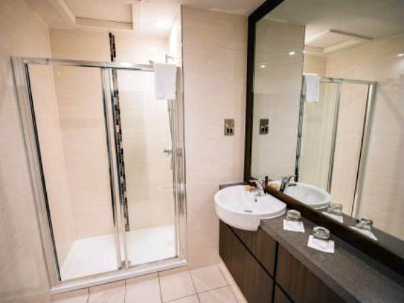 Relax in the private bathroom in your room at Links Hotel
