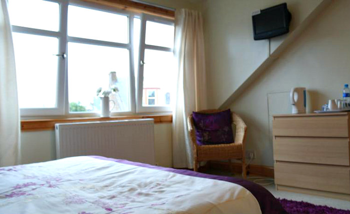 Put your feet up in front of the TV in your room at ATuras-Mara Guest House