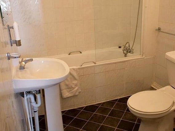 Relax in the private bathroom in your room at Rose Court Marble Arch