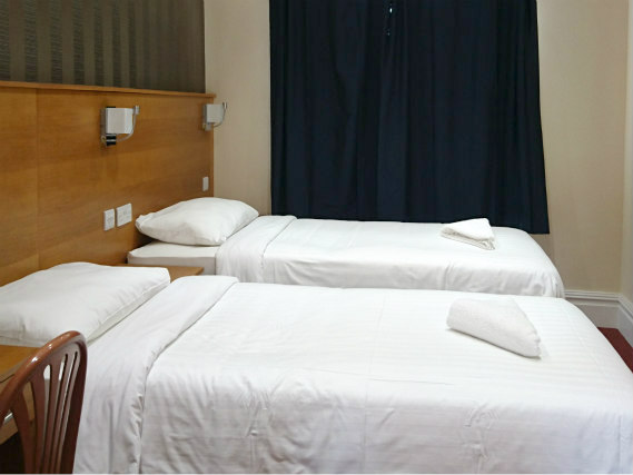 A twin room at Mina House Hotel London