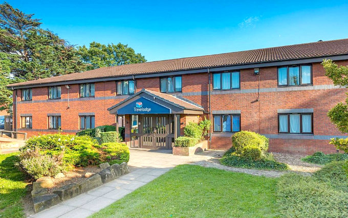 The attractive gardens and exterior of Travelodge London Ilford