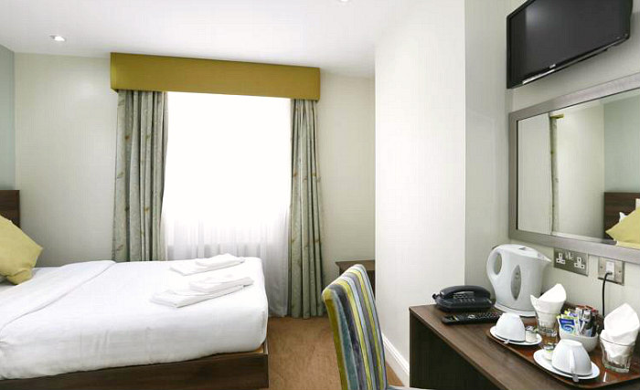 Put your feet up in front of the TV in your room at Hyde Park Boutique Hotel