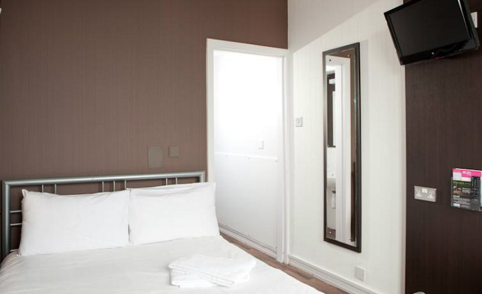 Put your feet up in front of the TV in your room at Euro Hostel Glasgow