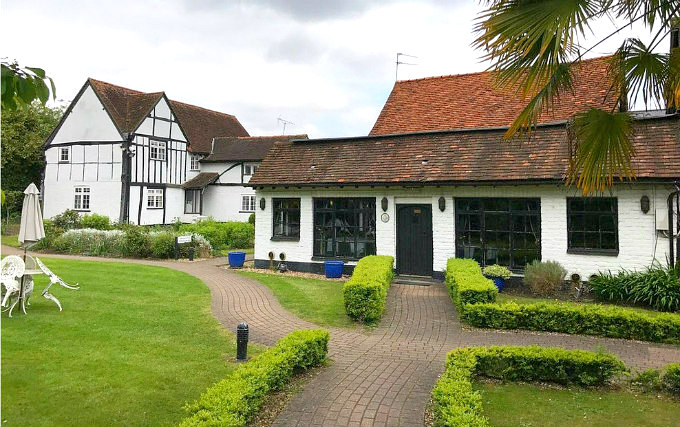 The attractive gardens and exterior of The Barn Hotel