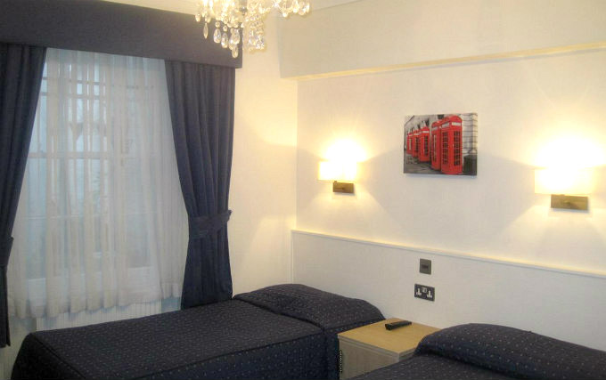 A twin room at Aaraya Hotel London