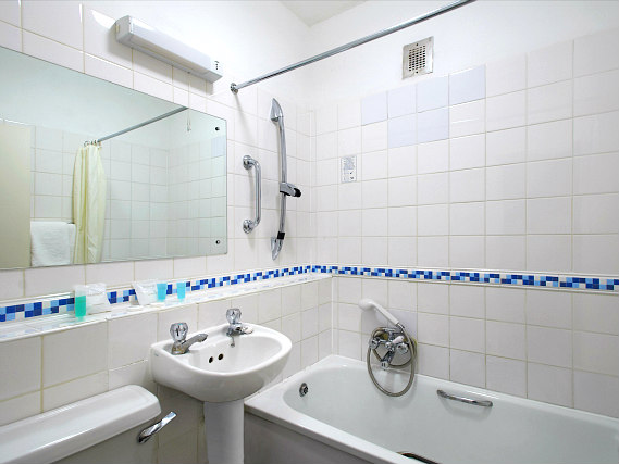 Relax in the private bathroom in your room at Ambassadors Hotel London Kensington