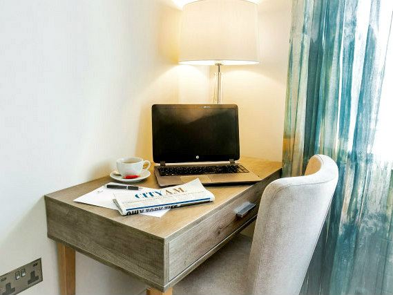 Most rooms have desks at the Astor Court Hotel